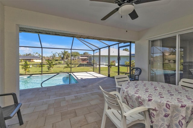 outdoor pool featuring a patio area, a ceiling fan, a lawn, and a lanai
