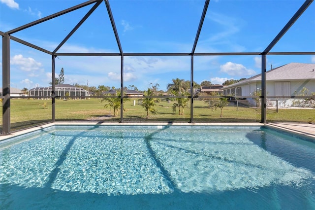 pool with glass enclosure and a lawn