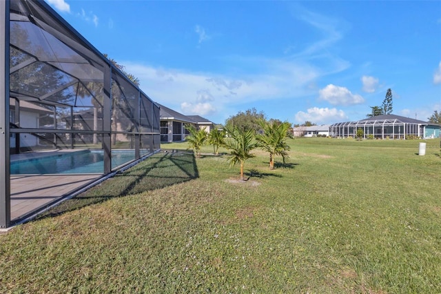 view of yard featuring glass enclosure and an outdoor pool