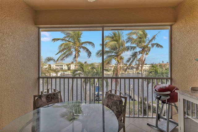 sunroom / solarium featuring a water view