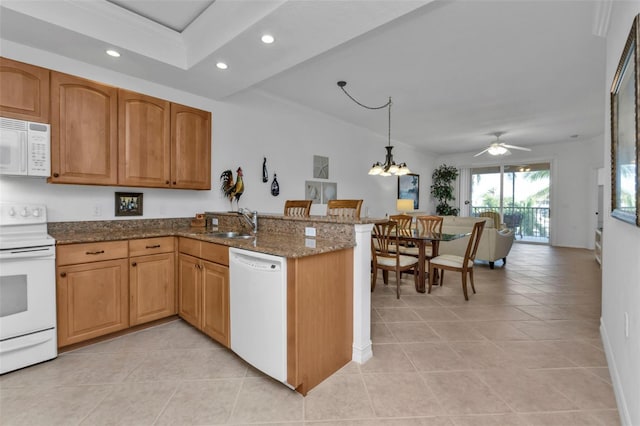 kitchen featuring ceiling fan with notable chandelier, decorative light fixtures, white appliances, and kitchen peninsula