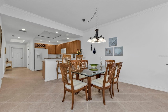 dining area featuring a notable chandelier, light tile patterned flooring, crown molding, and a tray ceiling