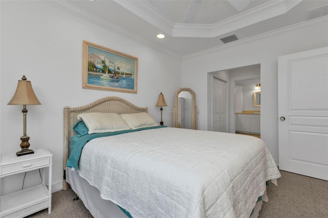 bedroom with a raised ceiling, carpet floors, ensuite bath, and crown molding