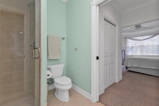 bathroom featuring tile patterned floors, ceiling fan, a shower with door, and crown molding