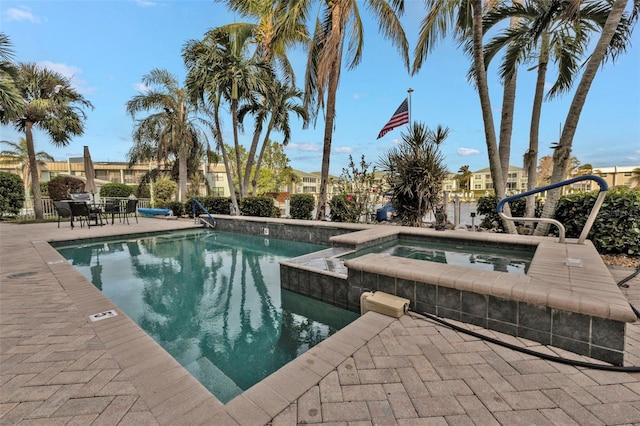 view of swimming pool with a community hot tub and a patio