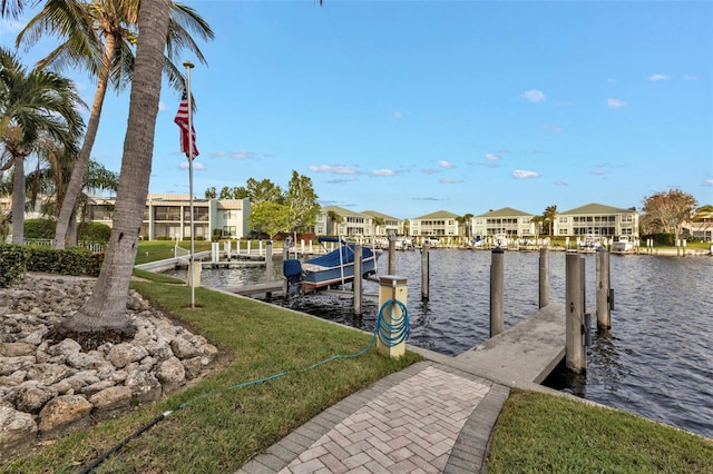 view of dock featuring a water view and a lawn