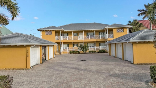 exterior space with a garage and a balcony