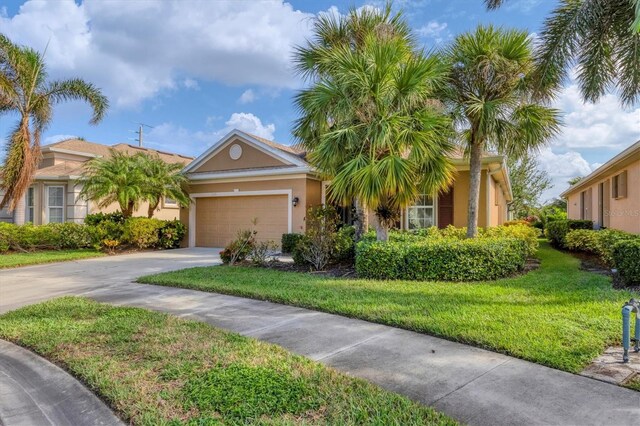 view of front of home with a front yard and a garage