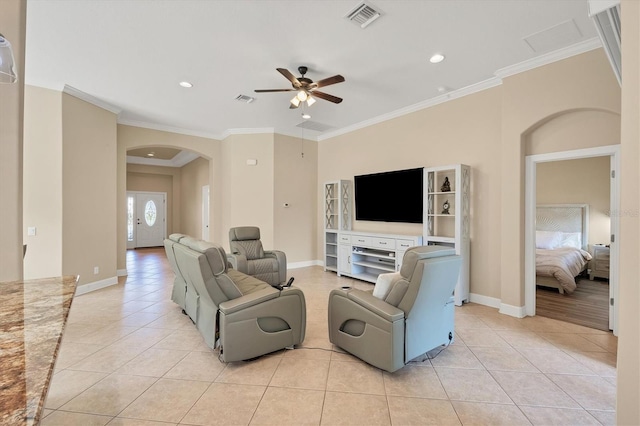 tiled living room featuring ceiling fan and ornamental molding