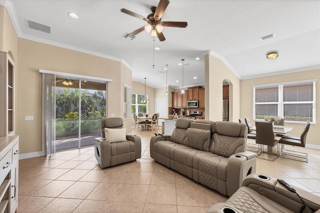 living room with ceiling fan, lofted ceiling, crown molding, and light tile patterned floors