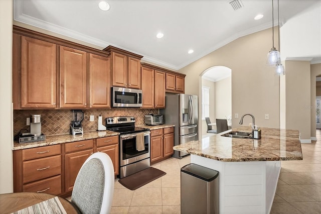 kitchen with a center island with sink, sink, crown molding, light stone counters, and stainless steel appliances