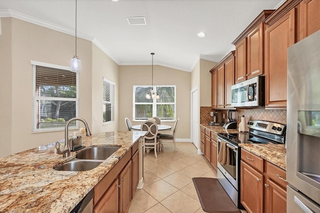 kitchen with pendant lighting, a wealth of natural light, sink, and appliances with stainless steel finishes