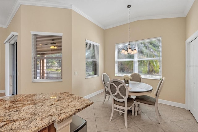 tiled dining room with lofted ceiling, a wealth of natural light, crown molding, and a notable chandelier