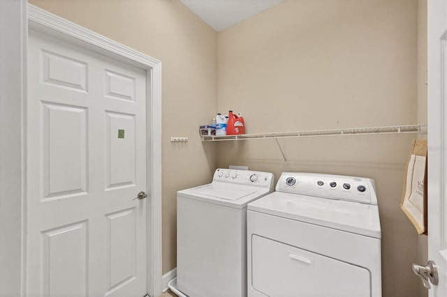 clothes washing area featuring washer and dryer