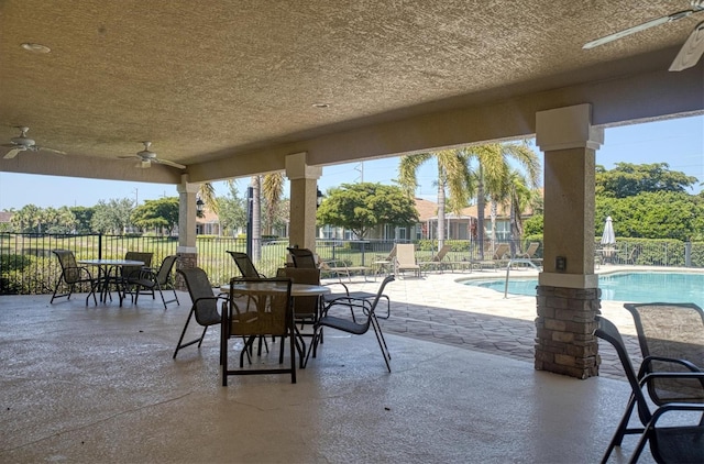 view of patio featuring ceiling fan and a community pool