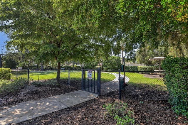 view of gate with a lawn