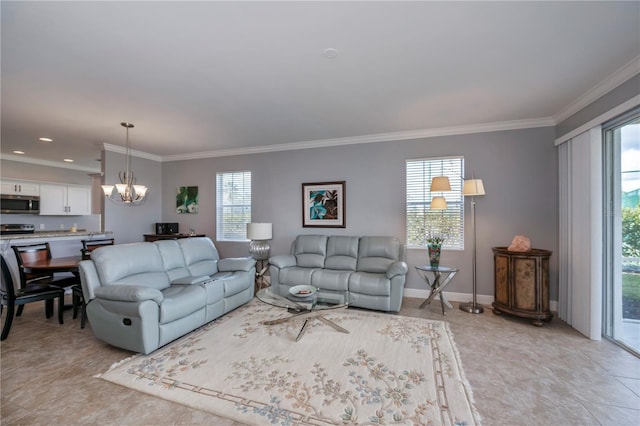 tiled living room featuring a healthy amount of sunlight, crown molding, and an inviting chandelier