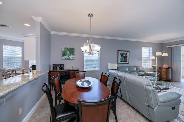 dining space with a chandelier and crown molding