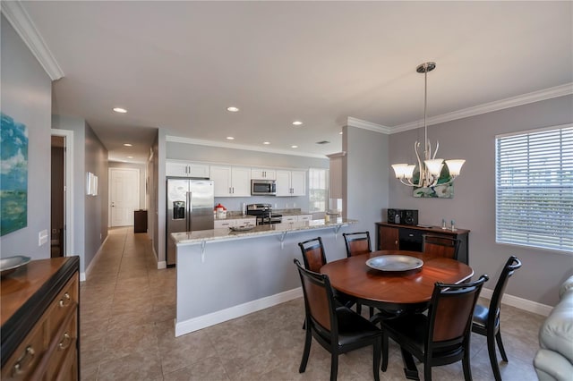 tiled dining room featuring a chandelier and ornamental molding