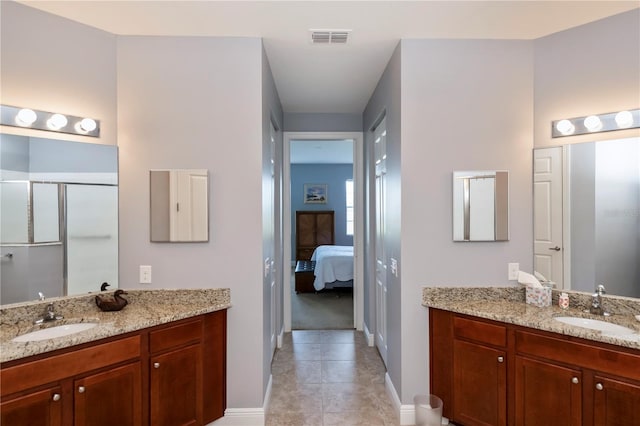 bathroom featuring tile patterned flooring, vanity, and an enclosed shower