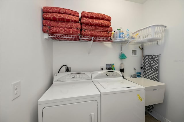 clothes washing area with sink and washing machine and clothes dryer