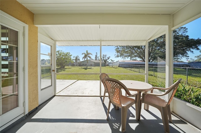 sunroom / solarium featuring vaulted ceiling