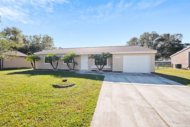 single story home with central air condition unit, a front yard, and a garage