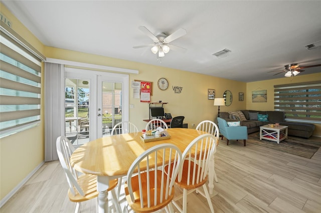 dining room featuring ceiling fan, french doors, and light hardwood / wood-style flooring