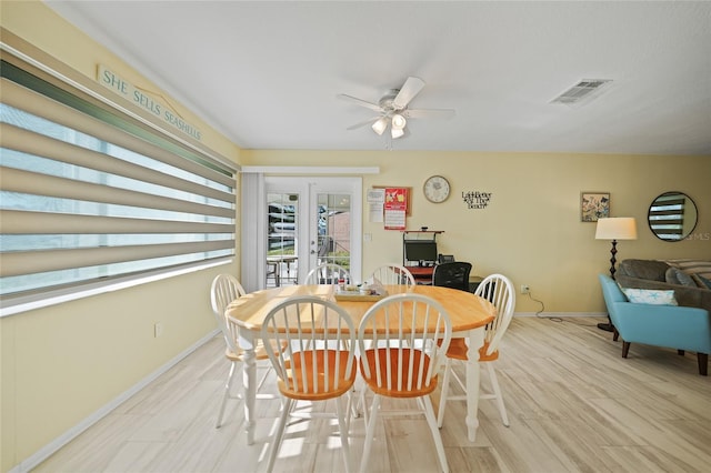 dining area featuring ceiling fan, light wood-type flooring, and french doors