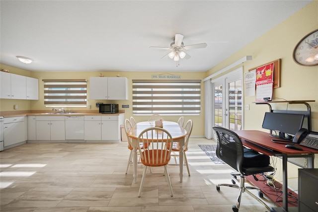 interior space featuring french doors, ceiling fan, and sink