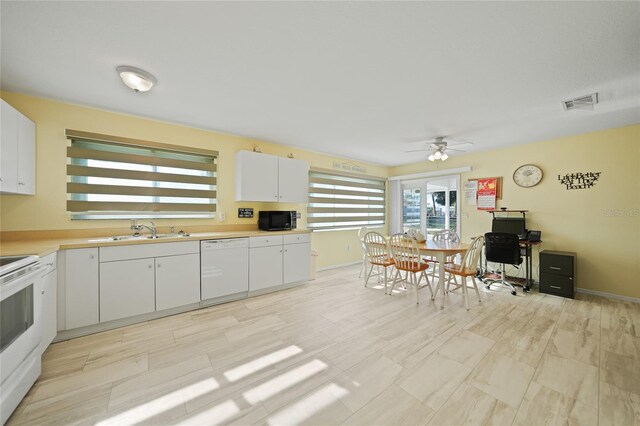 kitchen featuring white appliances, white cabinetry, ceiling fan, and sink