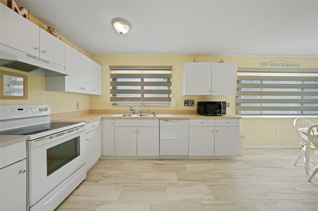 kitchen with white cabinetry, sink, and white appliances