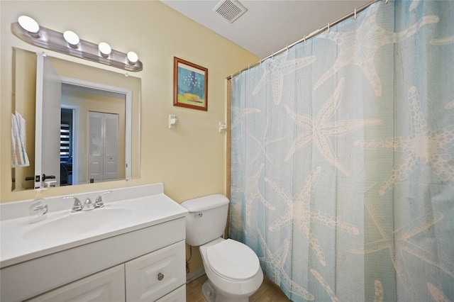 bathroom with vanity, toilet, and curtained shower