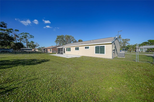 rear view of house with a yard and a patio