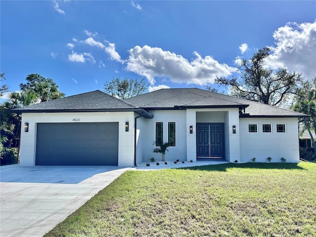 view of front of house featuring a front yard and a garage