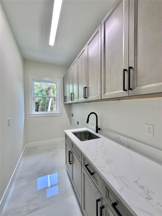 laundry area with electric dryer hookup, sink, cabinets, and washer hookup