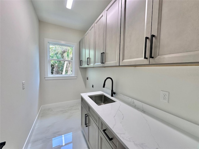 laundry room with sink and cabinets