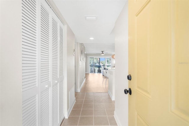 hall with tile patterned floors