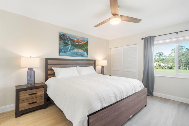 bedroom featuring ceiling fan, a closet, and light hardwood / wood-style floors