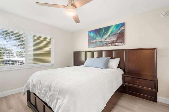 bedroom with ceiling fan and light wood-type flooring