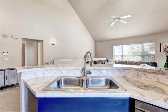 kitchen featuring ceiling fan, light colored carpet, sink, and high vaulted ceiling