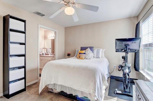 carpeted bedroom with connected bathroom and ceiling fan