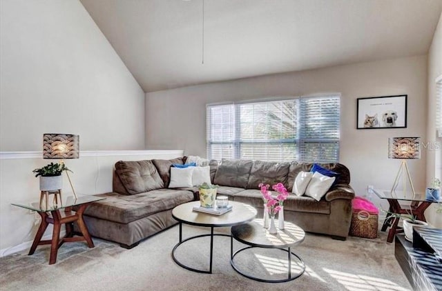 carpeted living room featuring lofted ceiling