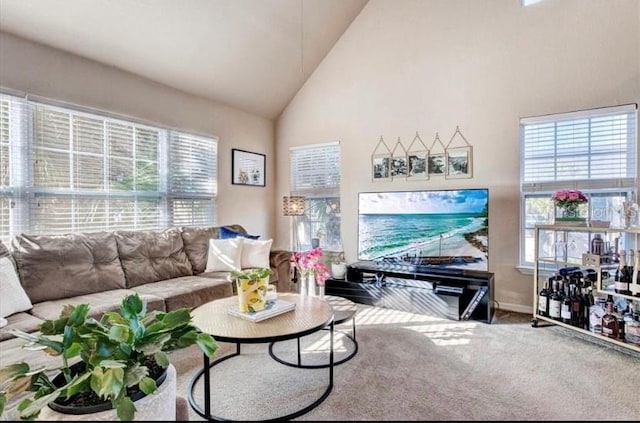 carpeted living room featuring high vaulted ceiling