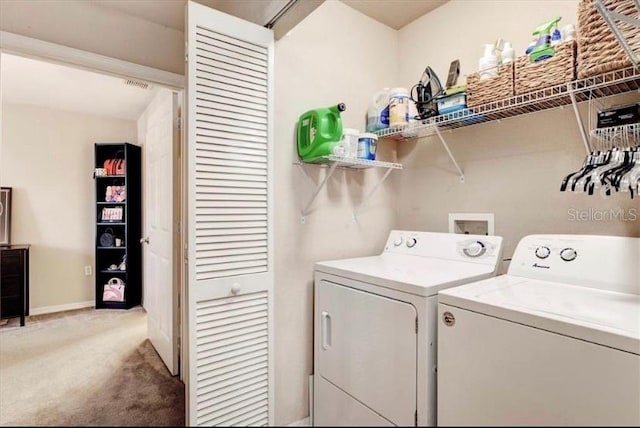 clothes washing area with carpet flooring and separate washer and dryer