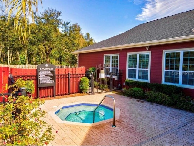 view of pool featuring a community hot tub and a patio