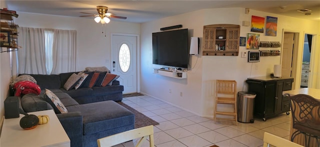 tiled living room featuring ceiling fan