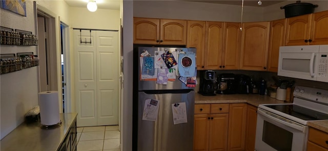 kitchen featuring white appliances and light tile patterned floors