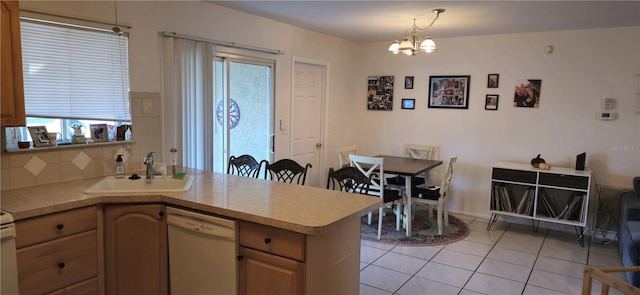 kitchen with sink, decorative light fixtures, light tile patterned floors, dishwasher, and a wealth of natural light