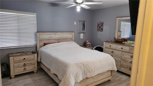 bedroom featuring light hardwood / wood-style flooring and ceiling fan